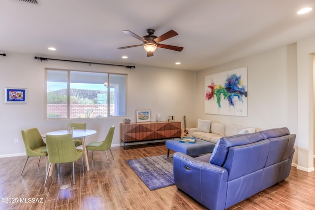 living area with recessed lighting, baseboards, wood finished floors, and a ceiling fan