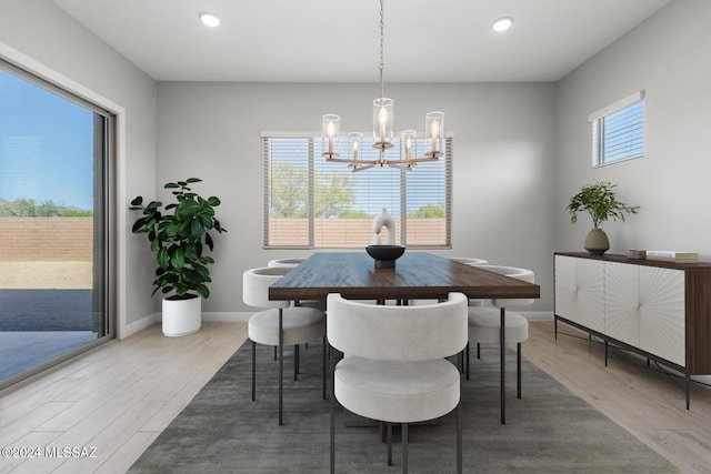 dining space featuring a wealth of natural light, baseboards, wood finished floors, and recessed lighting