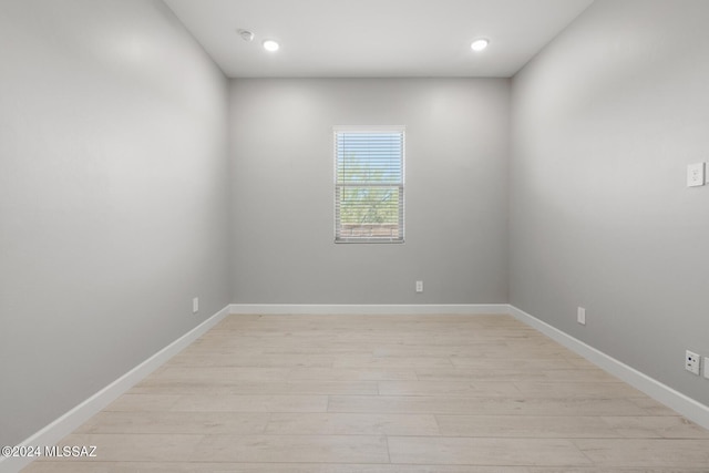 empty room featuring baseboards, recessed lighting, and light wood-style floors