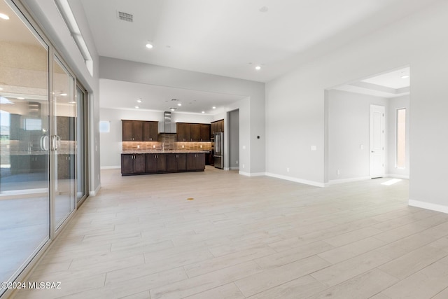 unfurnished living room featuring light wood-style flooring, recessed lighting, visible vents, and baseboards