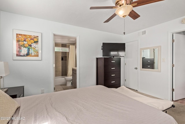 carpeted bedroom with visible vents and ensuite bathroom