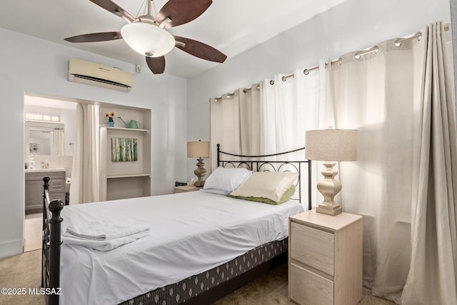 carpeted bedroom with ceiling fan, ensuite bathroom, and a wall mounted AC