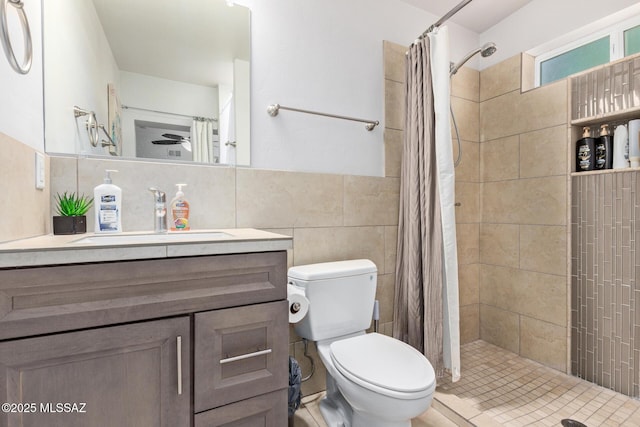 full bath with tiled shower, tile walls, toilet, and vanity