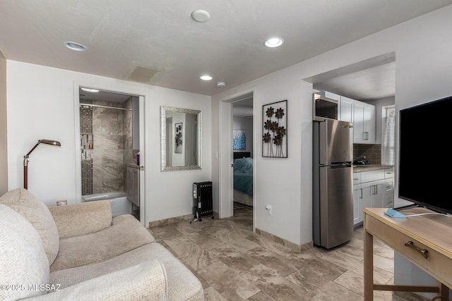 living area with radiator, marble finish floor, baseboards, and recessed lighting