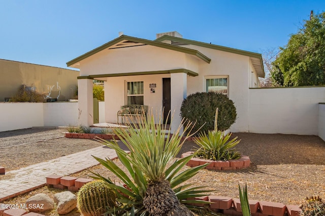 exterior space featuring fence and stucco siding