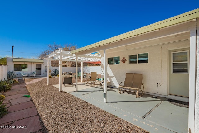 view of patio featuring fence and a pergola