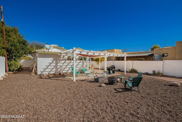 exterior space with a patio area, a fenced backyard, a fire pit, and a pergola