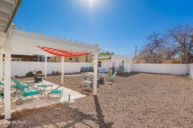 view of yard featuring a patio area, a fenced backyard, and a pergola