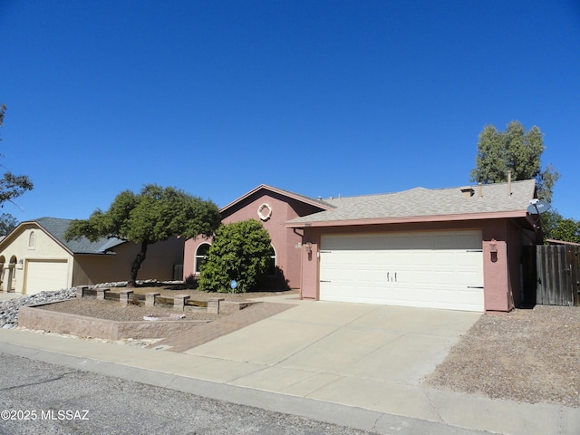 ranch-style home featuring a garage, driveway, and stucco siding