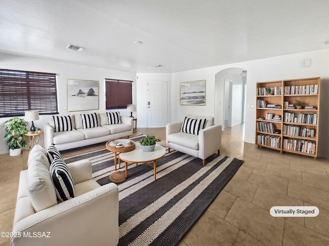 living area with arched walkways and visible vents