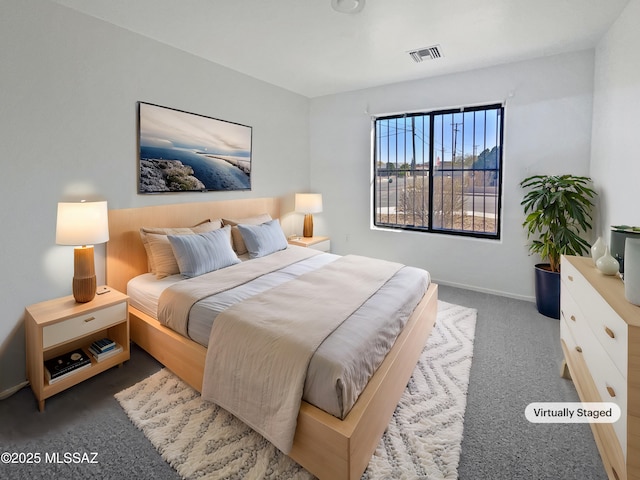 bedroom featuring baseboards, visible vents, and dark carpet