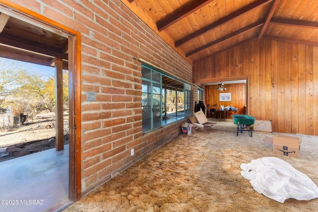 interior space featuring wood ceiling, vaulted ceiling with beams, and wood walls