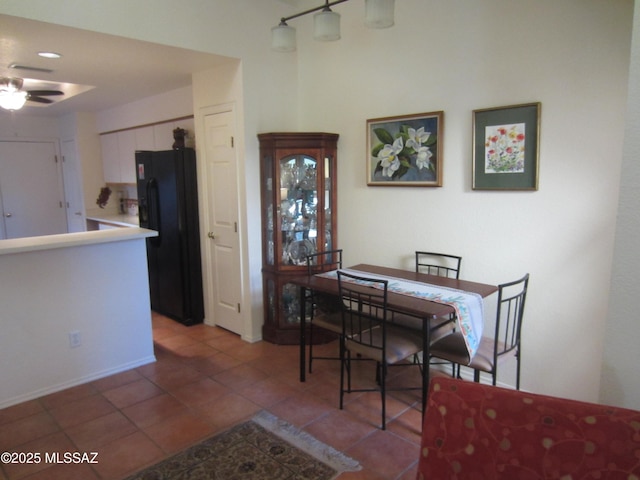 dining space featuring light tile patterned floors and a ceiling fan