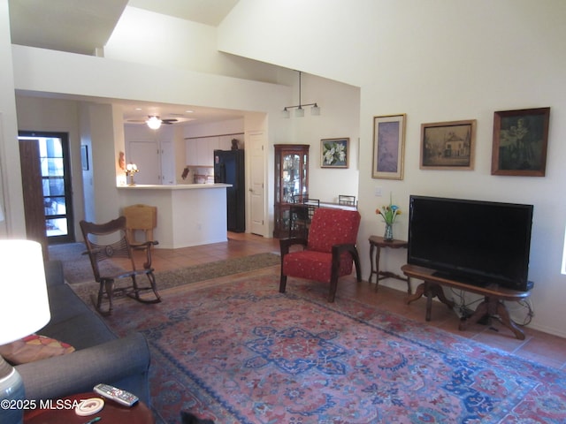 living area featuring tile patterned flooring and vaulted ceiling