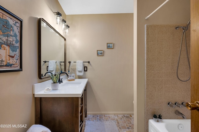 full bathroom with washtub / shower combination, baseboards, and vanity