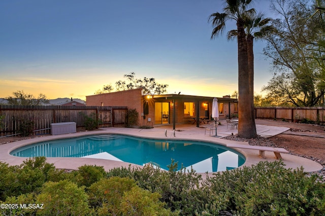 view of swimming pool featuring a diving board, a patio area, a fenced backyard, and a fenced in pool