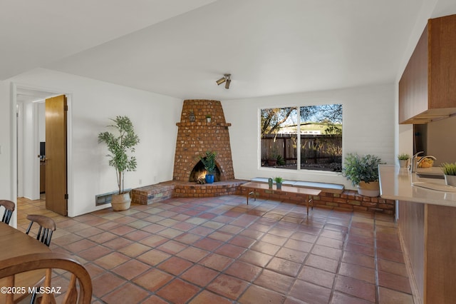 living area featuring visible vents, a fireplace, and light tile patterned floors