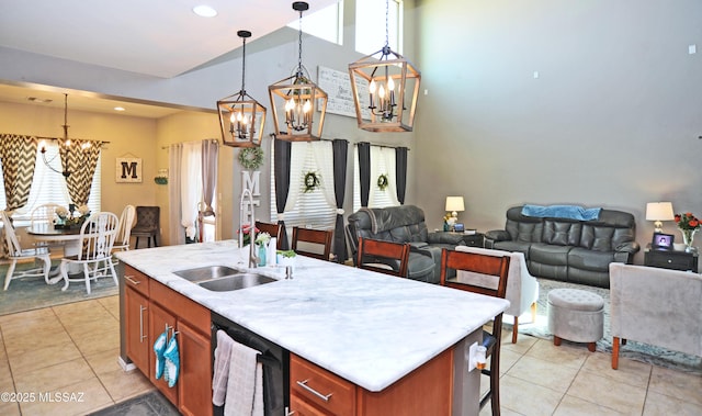 kitchen with light countertops, open floor plan, a sink, a chandelier, and dishwashing machine