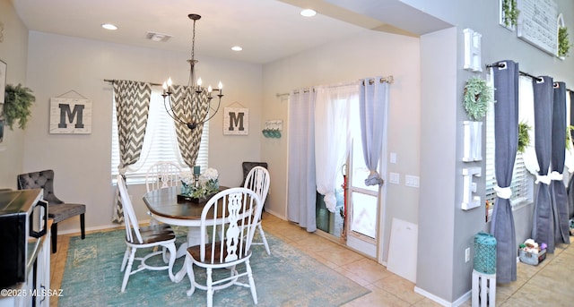 dining space with light tile patterned flooring, recessed lighting, a notable chandelier, visible vents, and baseboards