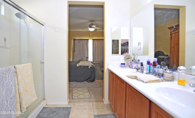 ensuite bathroom featuring a sink, tile patterned floors, ensuite bath, and a shower stall