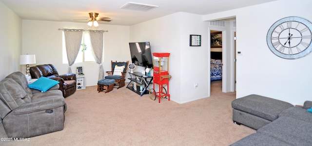 carpeted living room featuring visible vents and a ceiling fan