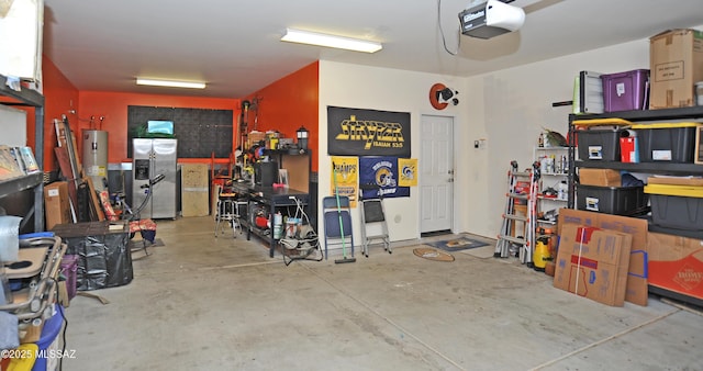 garage with a garage door opener, electric water heater, stainless steel fridge with ice dispenser, and a workshop area