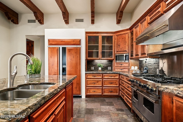 kitchen with visible vents, appliances with stainless steel finishes, ventilation hood, and glass insert cabinets