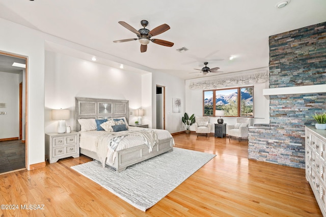 bedroom with light wood-style flooring, visible vents, and baseboards