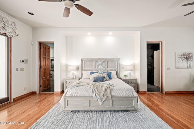 bedroom with light wood-type flooring, baseboards, and a ceiling fan