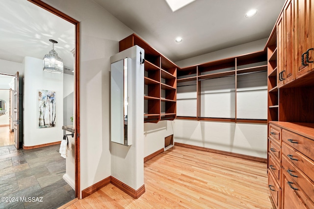 walk in closet featuring light wood-style flooring