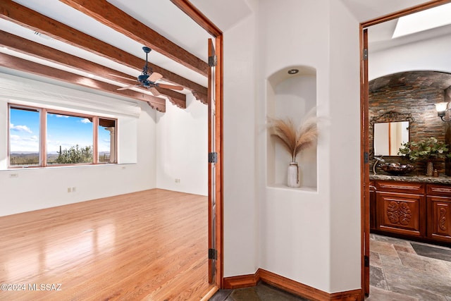 hallway featuring beamed ceiling