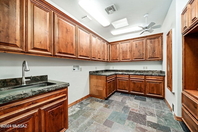 laundry area with cabinet space, visible vents, stone finish floor, hookup for a washing machine, and a sink