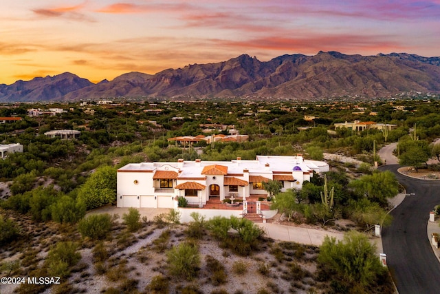 aerial view at dusk featuring a mountain view