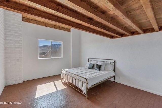 bedroom with beam ceiling, brick floor, and wood ceiling