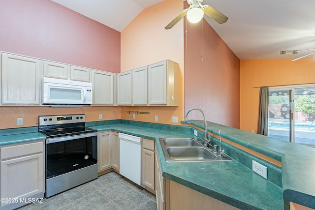 kitchen with light tile patterned floors, a peninsula, white appliances, a sink, and a ceiling fan