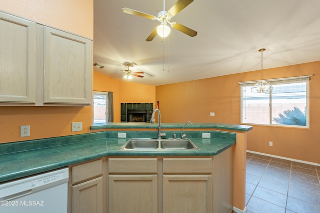 kitchen with plenty of natural light, white dishwasher, a sink, and visible vents