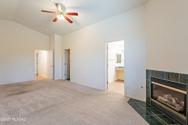 living area featuring dark colored carpet, a fireplace, high vaulted ceiling, and a ceiling fan