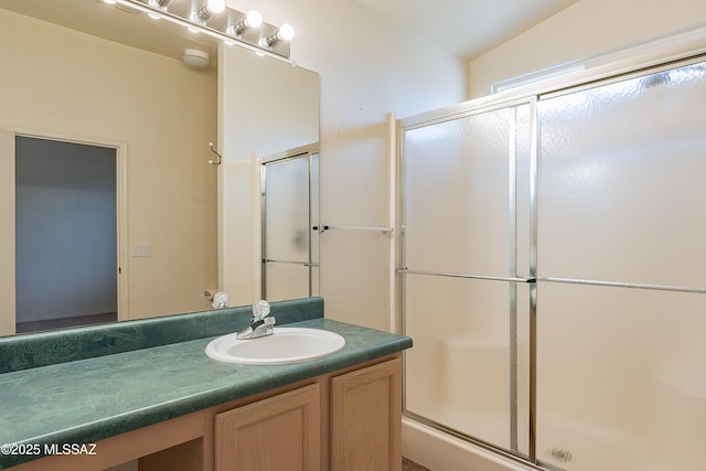 full bath with vanity and an enclosed shower