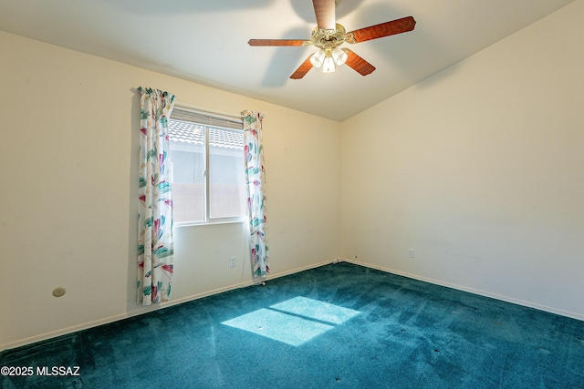 spare room featuring ceiling fan, dark carpet, and baseboards