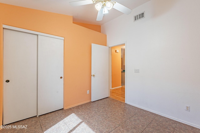 unfurnished bedroom with visible vents, baseboards, vaulted ceiling, a ceiling fan, and a closet