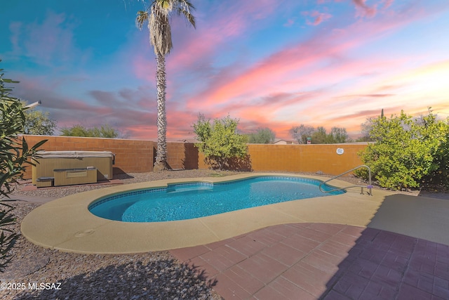 pool at dusk featuring a patio, a fenced backyard, a fenced in pool, and a hot tub