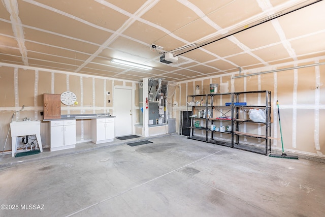 garage with heating unit, a sink, and a garage door opener