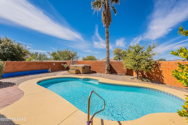 view of swimming pool featuring a patio area, a hot tub, a fenced in pool, and a fenced backyard