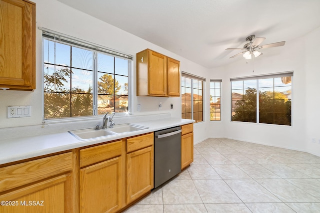 kitchen with light tile patterned floors, light countertops, stainless steel dishwasher, and a sink