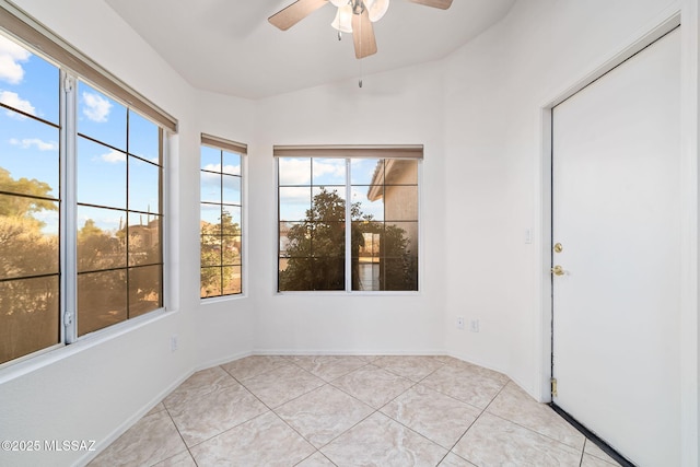 unfurnished sunroom featuring a ceiling fan