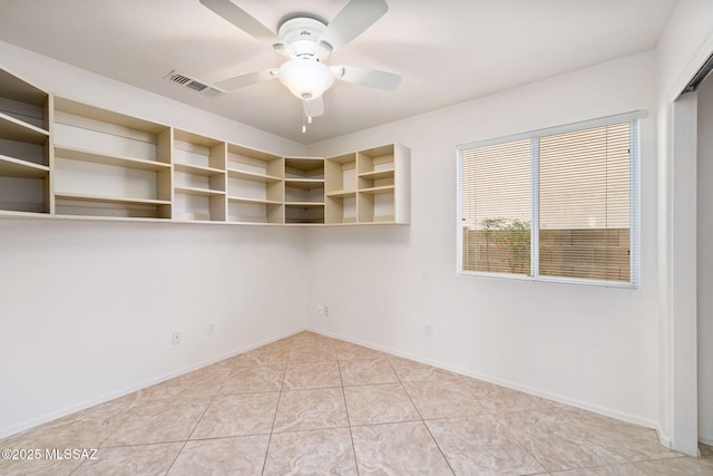 empty room with light tile patterned floors, baseboards, visible vents, and a ceiling fan