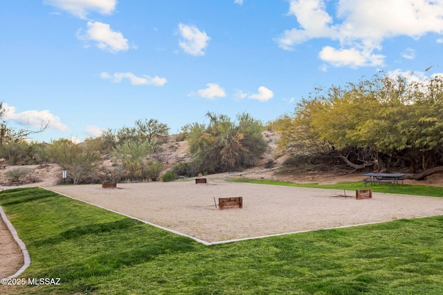 view of property's community featuring a yard