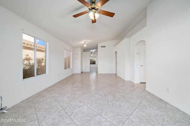 unfurnished room with arched walkways and ceiling fan