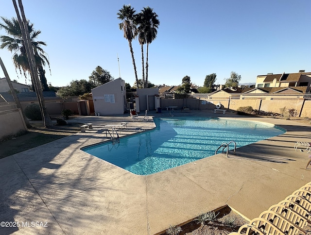 pool featuring a patio area and fence