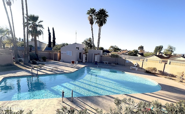 pool featuring a fenced backyard and a patio